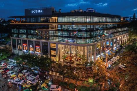 Road-facing view of Sobha Infinia with premium entrance, landscaped surroundings, modern architecture, and smooth connectivity
